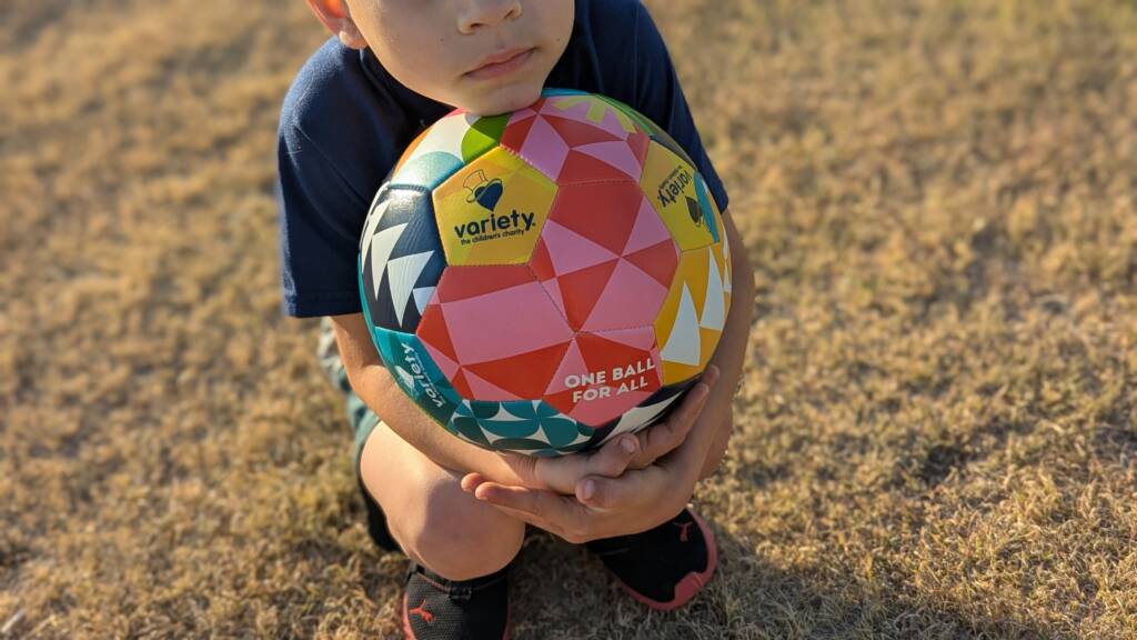Kid holding a soccer ball